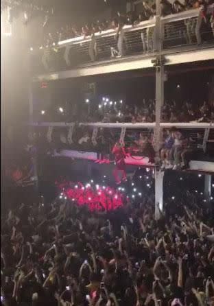 During his show at NYC's Terminal 5, Travis spoke to a fan who was hanging from a balcony railing. Source: Twitter
