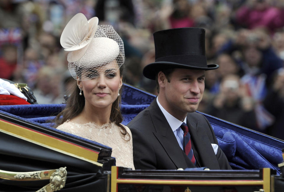 FILE - Britain's Prince William and Kate Duchess of Cambridge pass along The Mall as part of a four-day Diamond Jubilee celebration to mark the 60th anniversary of Queen Elizabeth's accession to the throne, London, Tuesday, June, 5, 2012. (AP Photo/Tom Hevezi, Pool, File)