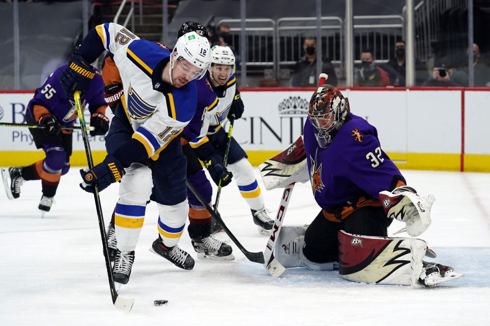 St. Louis Blues left wing Zach Michael Sanford (12) shoots on Arizona Coyotes goaltender Antti Raanta (32) in the first period during an NHL hockey game, Saturday, Feb. 13, 2021, in Glendale, Ariz. (AP Photo/Rick Scuteri)