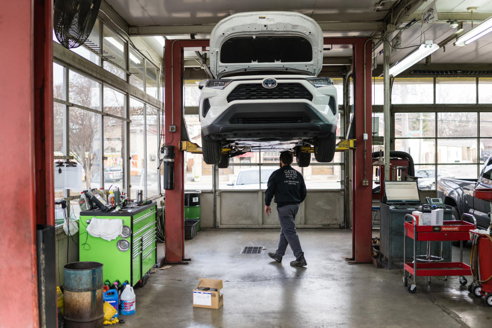 LOUISVILLE, KY - JANUARY 13: An auto mechanic walks from a lift under a vehicle being repaired at Gates Automotive Services in Louisville, Kentucky on January 13, 2022. Global supply chain slowdowns and labor shortages are making it difficult for many stores across the U.S. to order parts and fulfill service requests.  (Photo by John Cherry/Getty Images)