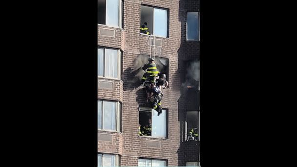 PHOTO:  A woman is rescued by NYFD firemen in an image taken from video posted to Twitter, after a fire in a Midtown Manhattan high-rise trapped residents in the morning of Nov.5, 2022, leaving several people injured, according to the FDNY. (Patti Ryan/Twitter)