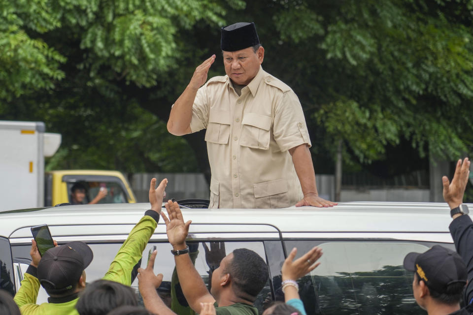 Indonesian Defense Minister and presidential frontrunner Prabowo Subianto greets supporters after visiting his father's grave in Jakarta, Indonesia Thursday, Feb. 15, 2024. The wealthy ex-general looks set to be the country's next president after unofficial tallies showed him taking a clear majority in the first round of voting. (AP Photo/Tatan Syuflana)