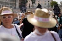 Women hold banners reading "Afghan sisters you're not alone" and "with the Afghan women" during a demonstration in favor of Afghan women's rights, staged by women rights activists, in Rome, Saturday, Sept. 25, 2021. (AP Photo/Andrew Medichini)