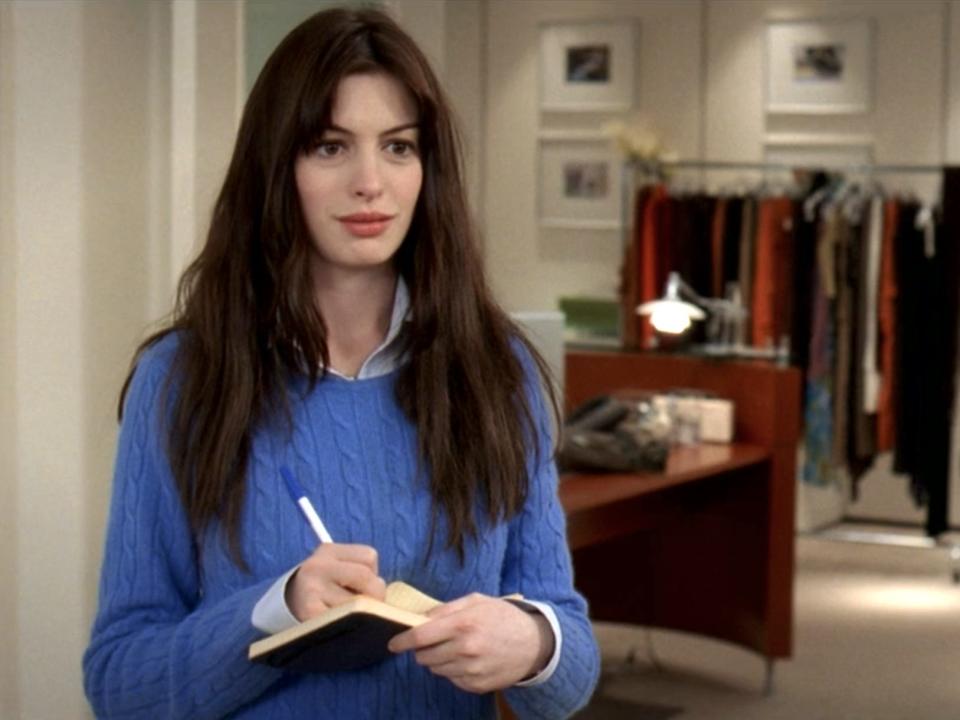 Anne Hathaway wearing a blue sweater as Andy Sachs in "The Devil Wears Prada."