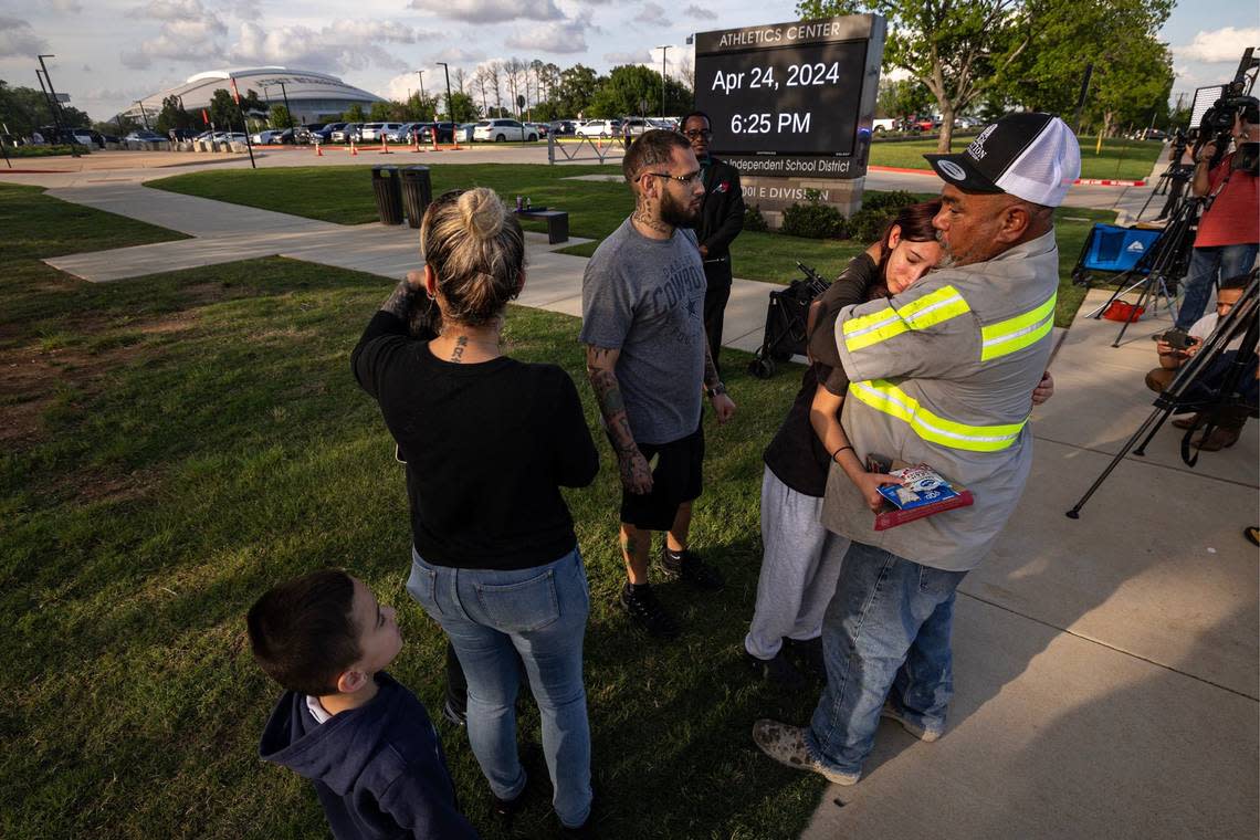 Freshman Amiah Barrera, 15, is comforted by her grandfather David Barrera after reuniting with her family at Arlington ISD Athletics Center on Wednesday, April 24, 2024. Bowie High School was put on lockdown after a shooting occurred on campus where one student was killed.