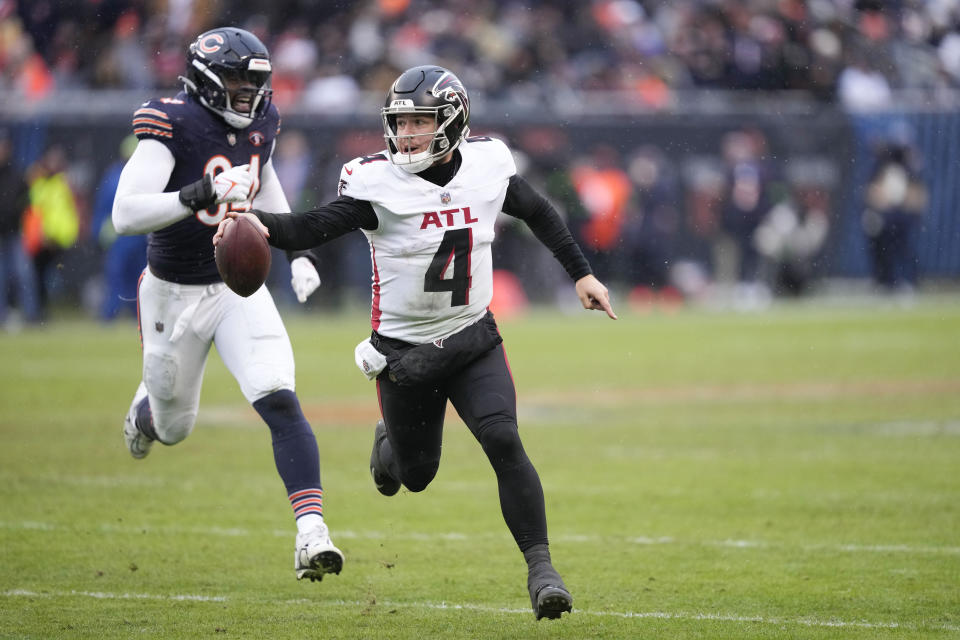 Atlanta Falcons quarterback Taylor Heinicke (4) runs in for a touchdown in the second half of an NFL football game against the Chicago Bears in Chicago, Sunday, Dec. 31, 2023. (AP Photo/Charles Rex Arbogast)
