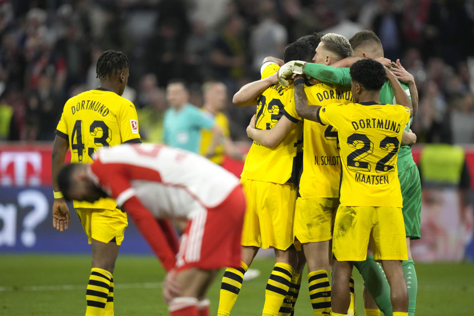 Borussia Dortmund players celebrate their victory at the German Bundesliga soccer match between FC Bayern Munich and Borussia Dortmund at the Allianz Arena stadium, in Munich, Germany, Saturday, March 30, 2024. (AP Photo/Matthias Schrader)