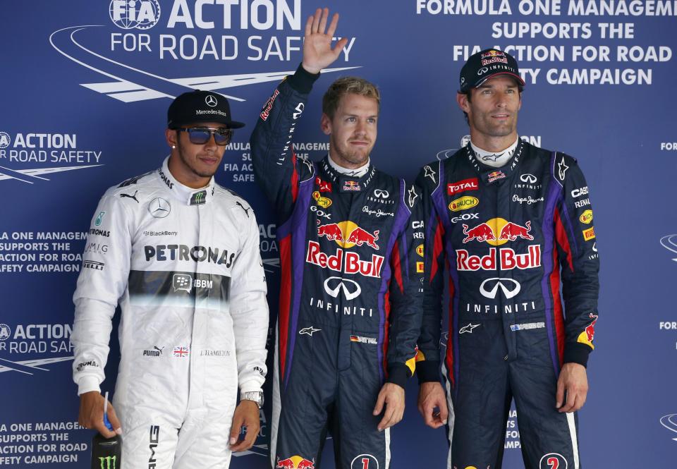(L-R) Mercedes Formula One driver Lewis Hamilton of Britain, Red Bull Formula One driver Sebastian Vettel of Germany and Red Bull Formula One driver Mark Webber of Australia pose for photographers after the qualifying session for the Korean F1 Grand Prix at the Korea International Circuit in Yeongam, October 5, 2013. Formula One championship leader Vettel will start Sunday's Korean Grand Prix on pole position for Red Bull with Hamilton's Mercedes alongside on the front row. REUTERS/Kim Hong-Ji (SOUTH KOREA - Tags: SPORT MOTORSPORT F1 TPX IMAGES OF THE DAY)