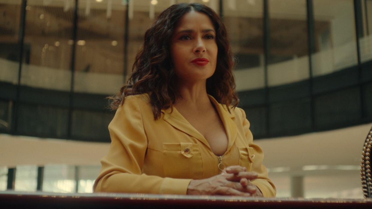  Salma Hayek standing looking out in Black Mirror. 