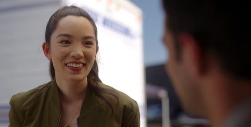 Jessica Van smiles while standing in front of a trailer