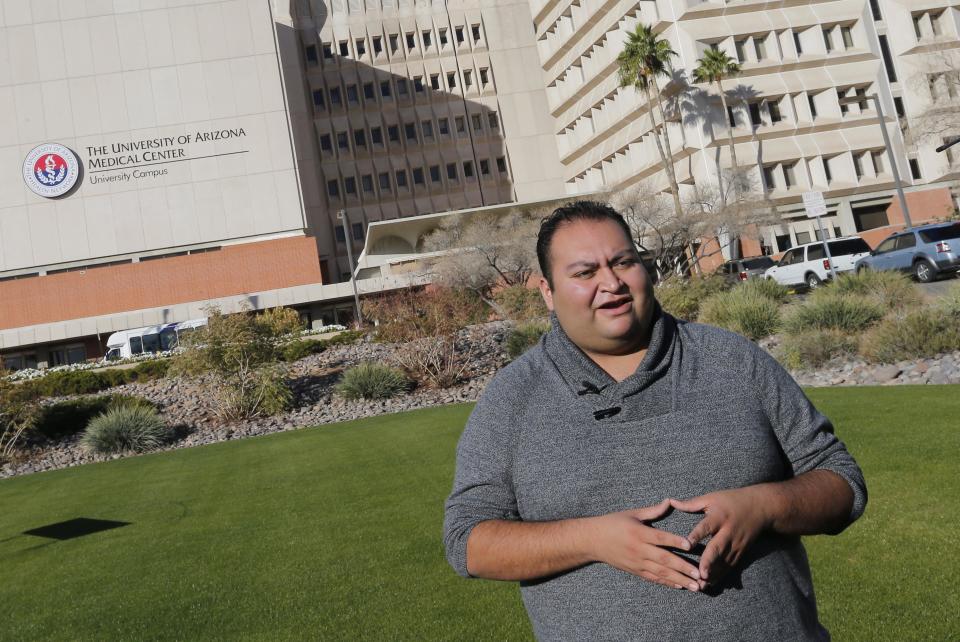 Daniel Hernandez Jr., a former intern for U.S Rep. Gabrielle Giffords, speaks prior to a remembrance ceremony on the third anniversary of the Tucson shootings, Wednesday, Jan. 8, 2014, in Tucson, Ariz. Six people were killed and 13 wounded, including Rep. Giffords, D-Ariz., in the shooting rampage at a community event hosted by Giffords in 2011. Hernandez attended to Giffords until paramedics arrived after the shooting. Jared Lee Loughner was sentenced in November 2012 to seven consecutive life sentences, plus 140 years, after he pleaded guilty to 19 federal charges in the shooting. (AP Photo/Matt York)