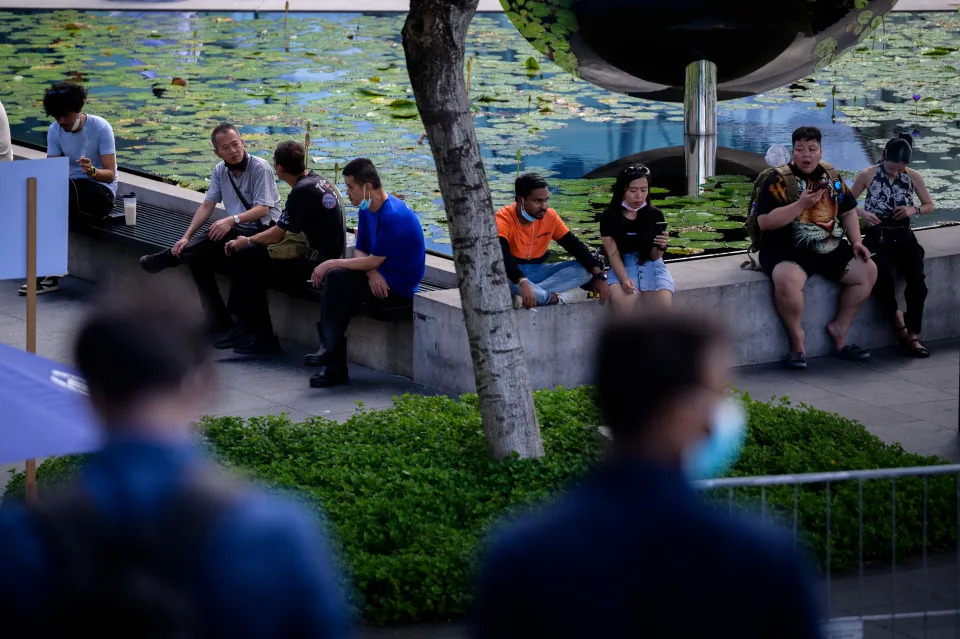 People sitting in a designated smoking area in the Marina Bay area in Singapore on 31 July, 2022, during the COVID-19 pandemic (PHOTO: NurPhoto via Getty Images)