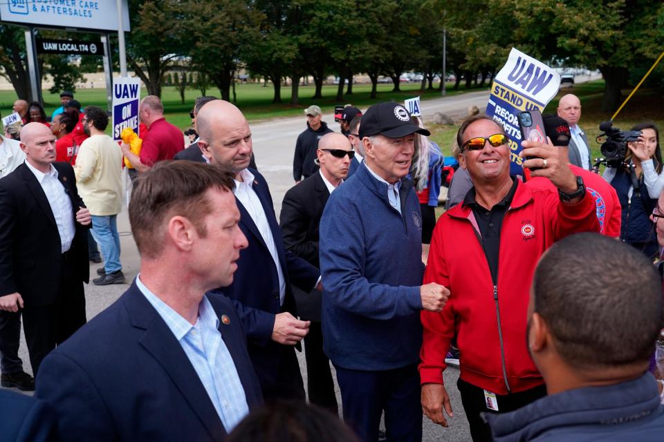 President Joe Biden speaks with workers picketing at General Motors Willow Run Redistribution in Van Buren Township on Tuesday, Sept. 26, 2023, during a stop in Michigan.