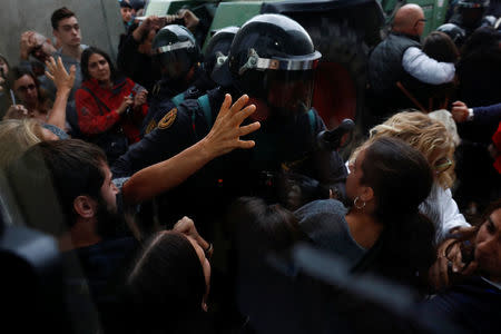 Scuffles break out as Spanish Civil Guard officers force their way through a crowd and into a polling station for the banned independence referendum where Catalan President Carles Puigdemont was supposed to vote in Sant Julia de Ramis, Spain October 1, 2017. REUTERS/Juan Medina