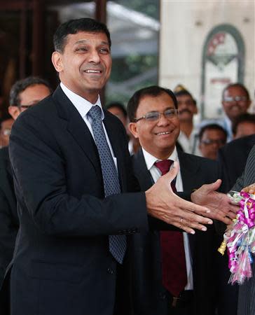 Raghuram Rajan, newly appointed governor of Reserve Bank of India (RBI), gestures while posing for the photographers after his arrival at the bank's headquarters in Mumbai September 4, 2013. REUTERS/Danish Siddiqui