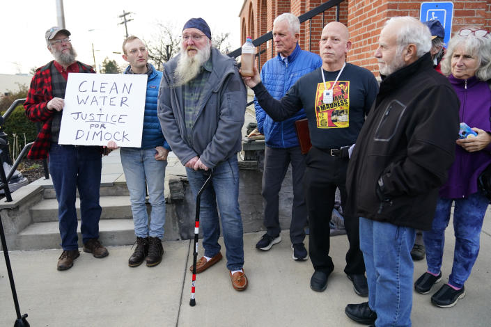 Ray Kemble of Dimock, Pa., third from left, speaks with members of the media outside the Susquehanna County Courthouse in Montrose, Pa., Tuesday, Nov. 29, 2022. Pennsylvania's most active gas driller has pleaded no contest to criminal environmental charges in a landmark pollution case. Houston-based Coterra Energy Inc. entered its plea Tuesday. (AP Photo/Matt Rourke)