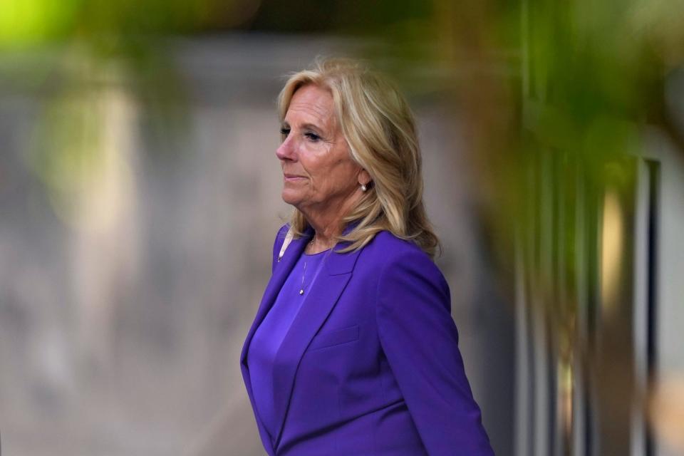 First Lady Jill Biden walks into federal court in Wilmington, Delaware, wearing a bright purple pants suit on the first day of Hunter Biden's gun trial.