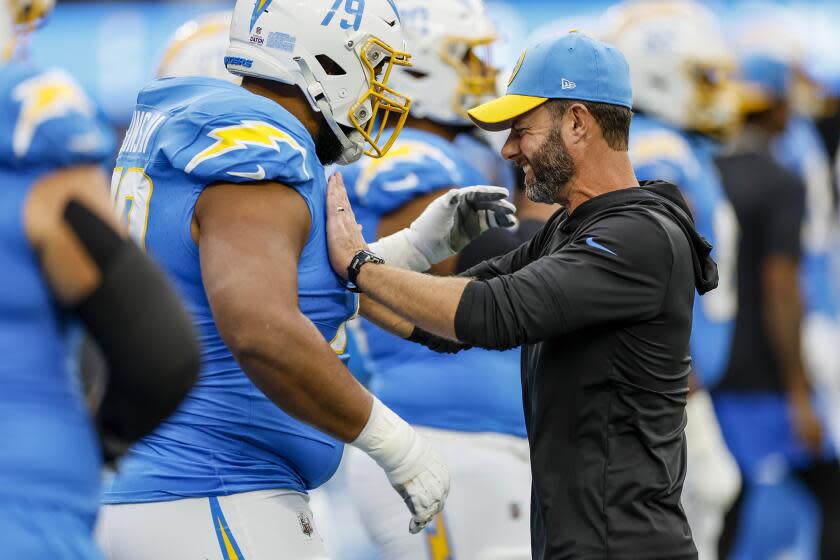 Chargers head coach Brandon Staley shares a moment with offensive tackle Trey Pipkins III.