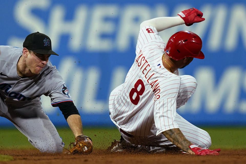 Philadelphia Phillies' Nick Castellanos seals second base past Miami Marlins' Joey Wendle during the sixth inning of a baseball game Tuesday, Aug. 9, 2022, in Philadelphia. (AP Photo/Matt Rourke)