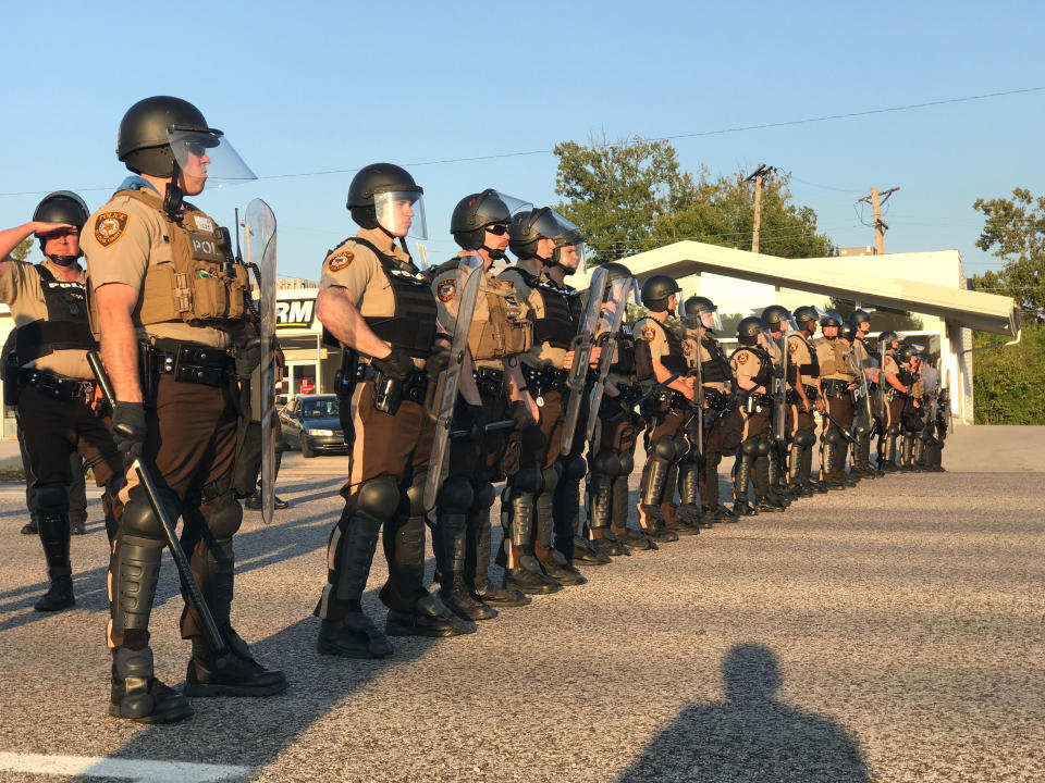 Riot police stand in a line near protesters in St. Louis County. (Photo: Ryan J. Reilly / HuffPost)