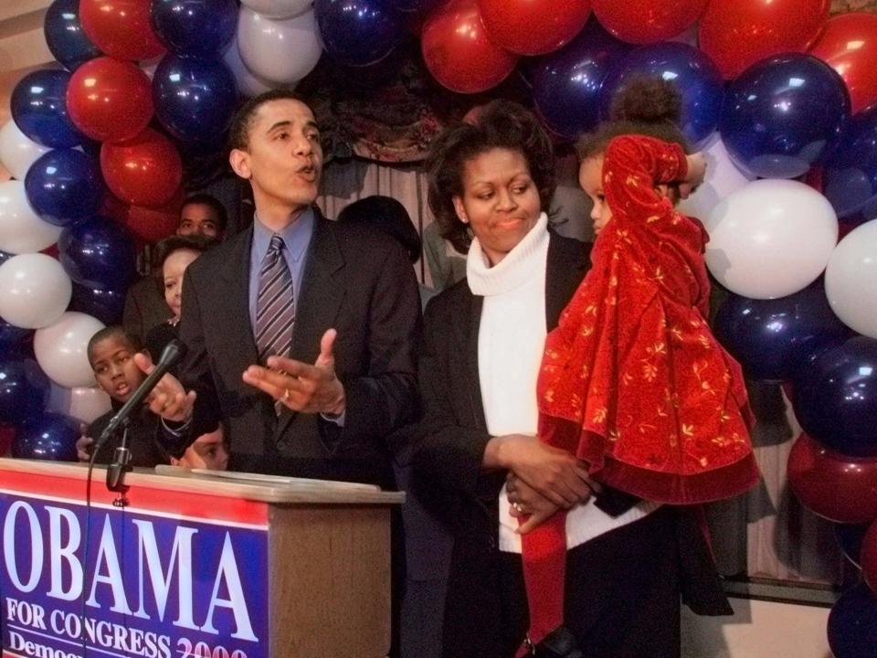 Barack and Michelle Obama with a young Malia at a campaign event while Barack ran for Congress.