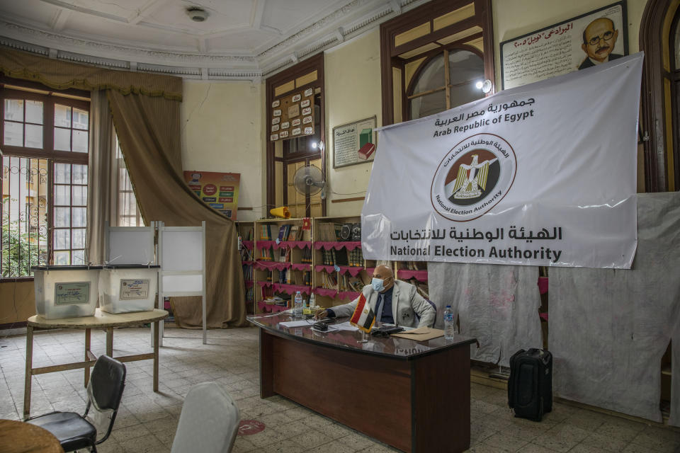 An election worker waits for voters inside a polling station on the first day in the second and final stage of the country's parliamentary elections in Cairo, Egypt, Saturday, Nov. 7, 2020. Egyptians began voting on Saturday after a relatively low turnout in the first stage that embarrassed the government of President Abdel-Fattah el-Sissi. (AP Photo/Nariman El-Mofty)