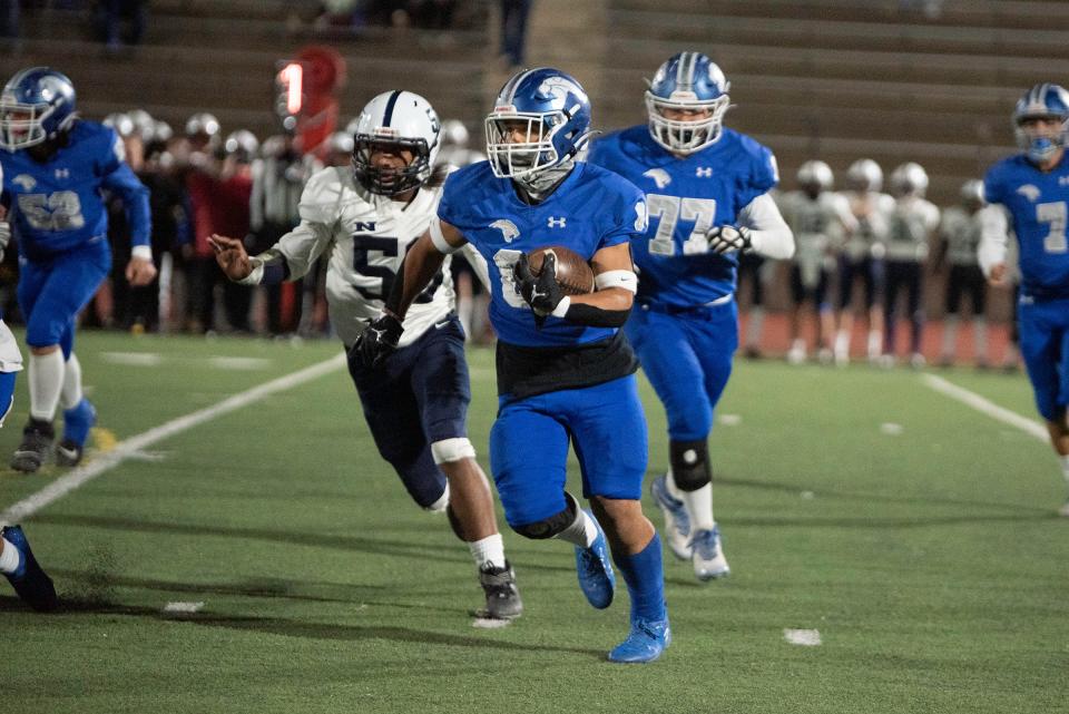 Pueblo Central's Amari Brown gains yards during the first round of the CHSAA Class 3A state playoffs against Northfield at Dutch Clark Stadium on Friday, November 10, 2023.