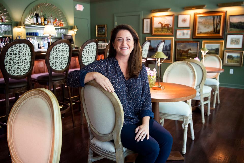 RT Lodge president Beth McCabe Holman is photographed inside the Morningside Room bar at RT Lodge in Maryville on Thursday, July 21, 2022. Before opening as a bar, the Morningside Room was a small lounge but has since expanded with a wooden bar, tables topped with European style lamps and paintings of horses and dogs hanging on green walls.