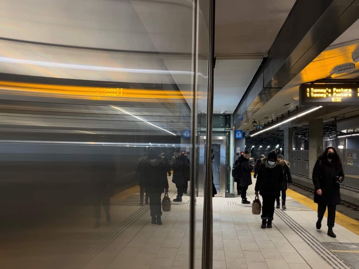 Commuters walk along the platform at Rideau station in Ottawa Jan. 10, 2023. The city's transit commission has set a ridership target of 70 per cent what it was before the pandemic. (Matthew Kupfer/CBC - image credit)