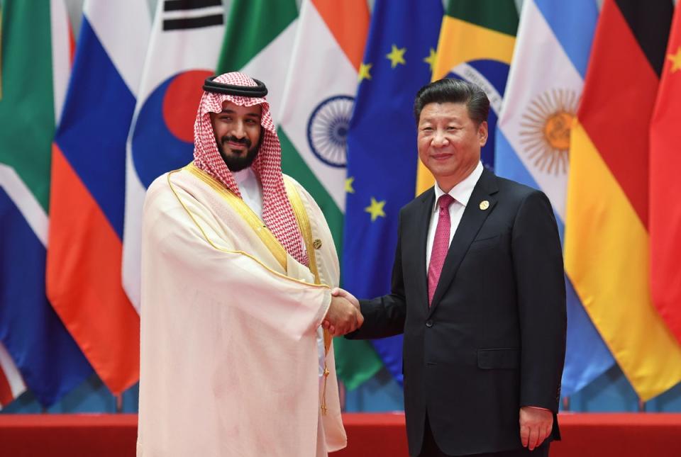 Saudi Arabia Crown Prince Mohammed bin Salman Al Saud shakes hands with China’s President Xi Jinping before the G20 leaders’ family photo in Hangzhou in 2016  (AFP via Getty Images)