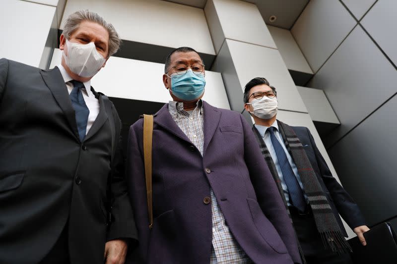 Media mogul and Apple Daily founder Jimmy Lai Chee-ying (C) leaves from a police station after being arrested for illegal assembly during the anti-government protests in Hong Kong