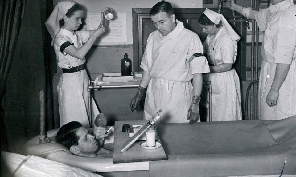 A patient enjoys a cigarette as he takes a saline bath at the Queen Victoria hospital in East Grinstead, West Sussex