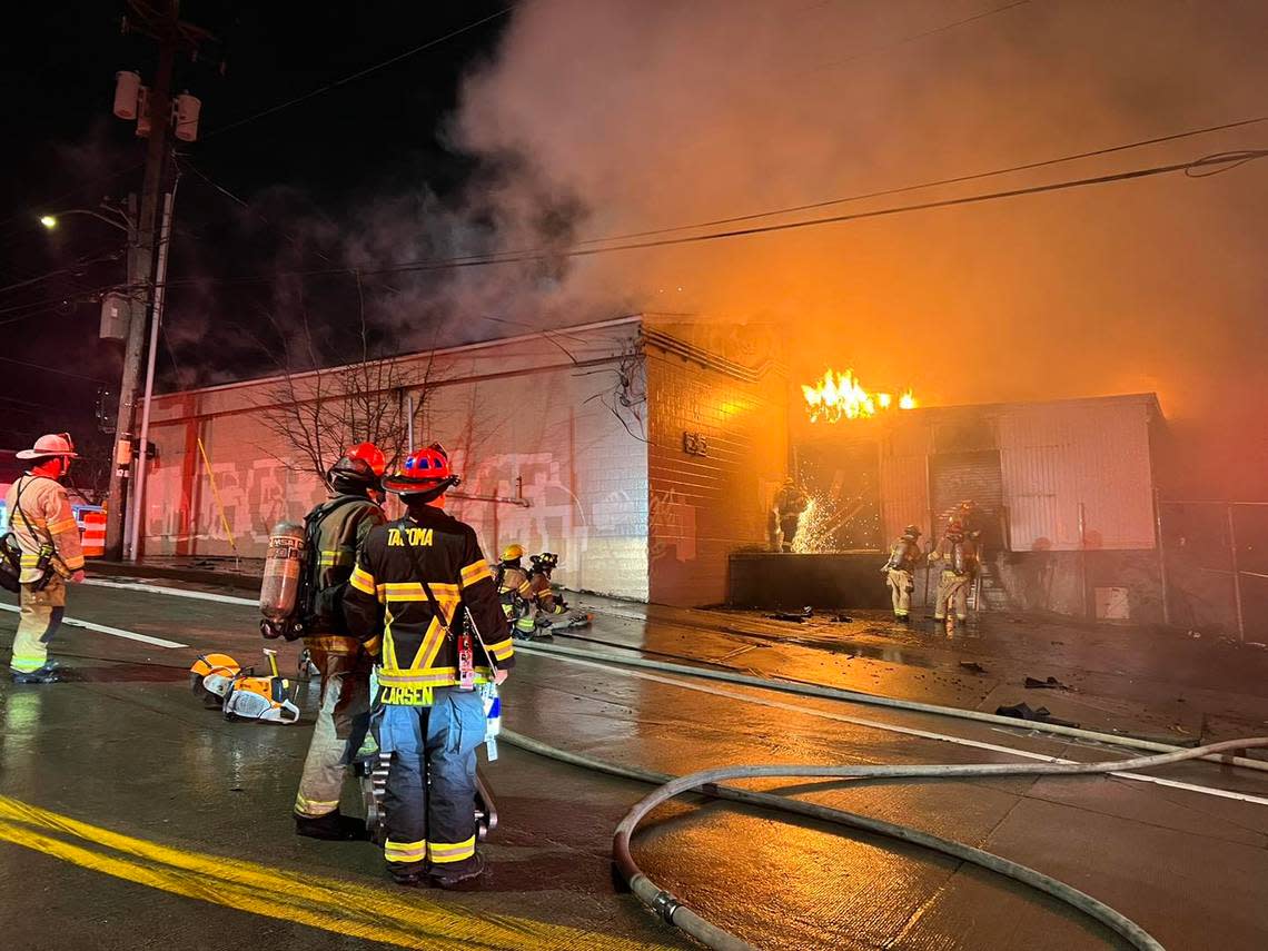 Tacoma Fire Department firefighters work the scene of a commercial building fire that broke out early Wednesday morning in a vacant building located at 323 E. 26th Street.