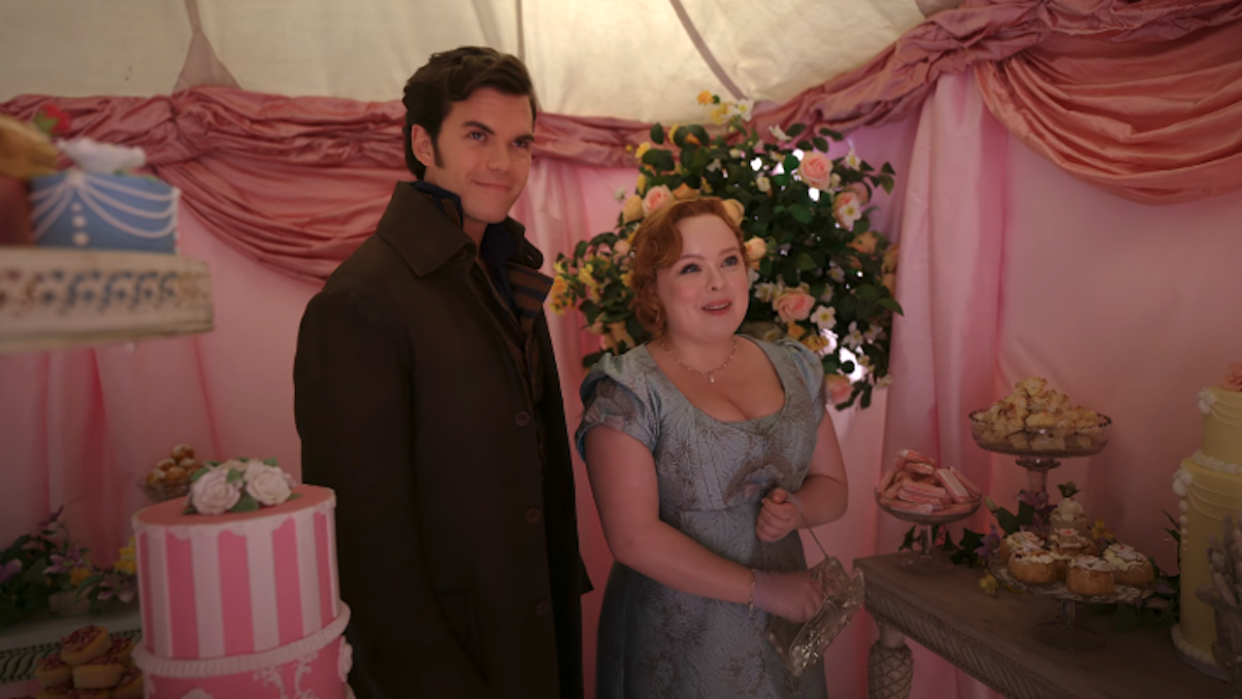  Colin Bridgerton and Penelope Featherington standing in a sweet shop in Season 3, Episode 3. 