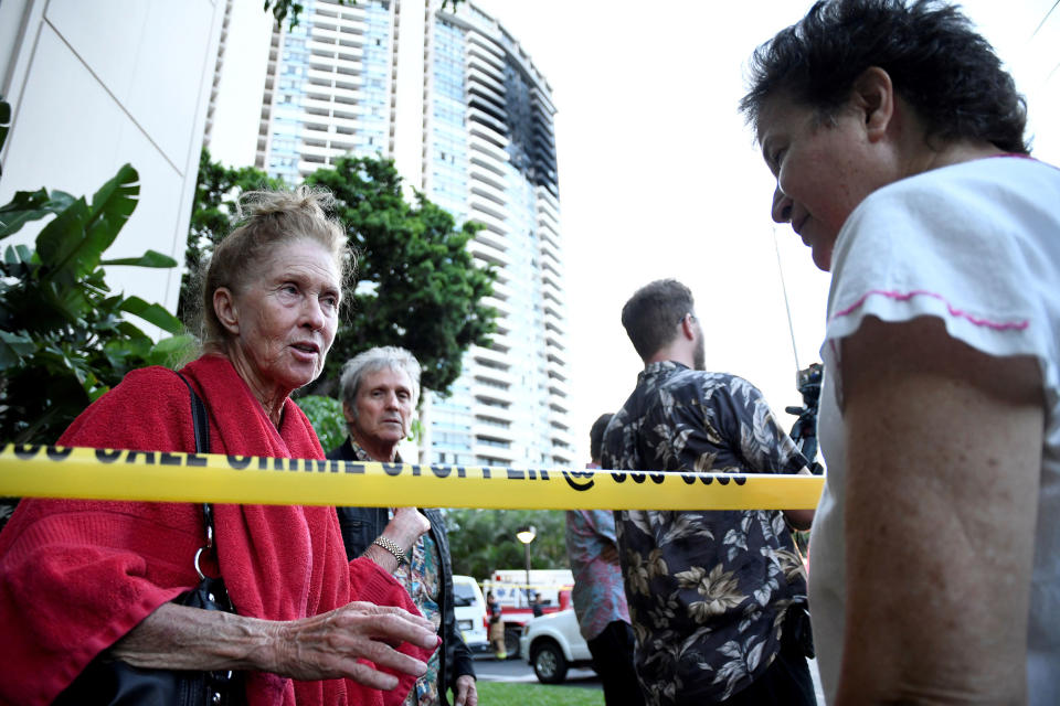 <p>Karen Hastings (L), who was evacuated from the floors where the fire broke out at Marco Polo apartment building, talks with another resident, in Honolulu, Hawaii, July 14, 2017. (Photo: Hugh Gentry/Reuters) </p>