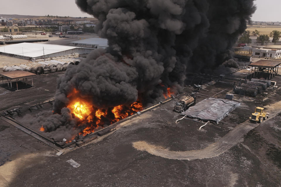 An oil refinery burns outside Irbil, Iraq, Thursday, June 13, 2024. (AP Photo/Bilind Tahir/Rudaw)