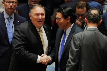 U.S. Secretary of State Mike Pompeo greets Israeli Ambassador to the United Nations, Danny Danon, before a meeting of the UN Security Council at UN headquarters in New York