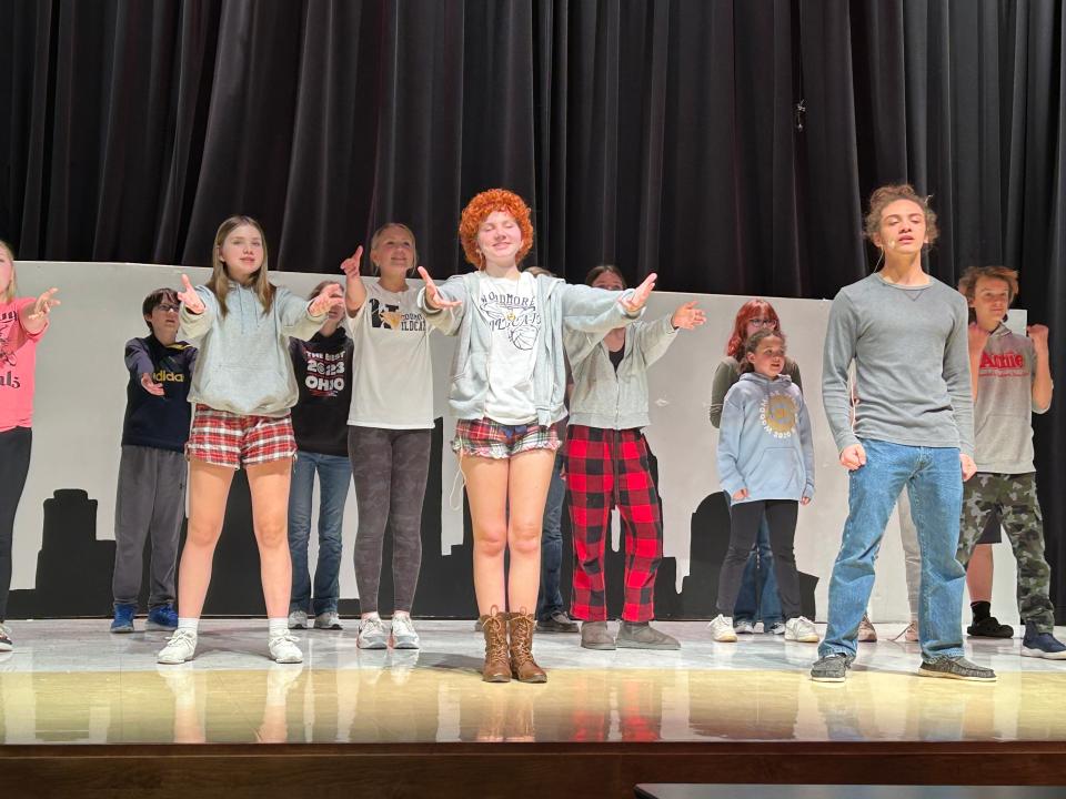 The cast of "Annie" rehearses for the Woodmore High School Drama Club production.