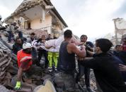 <p>A rescued woman is carried away on a stretcher following an earthquake in Amatrice Italy, Wednesday, Aug. 24, 2016. (Massimo Percossi/ANSA via AP) </p>
