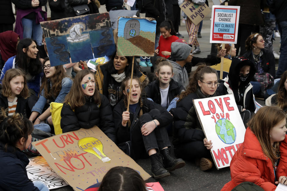 Youngsters sit in the road by Trafalgar Square as they take part in a student climate protest at the bottom of Westminster Bridge in London, Friday, March 15, 2019. Students in more than 80 countries and territories worldwide plan to skip class Friday in protest over their governments' failure to act against global warming. The coordinated 'school strike' was inspired by 16-year-old activist Greta Thunberg, who began holding solitary demonstrations outside the Swedish parliament last year. (AP Photo/Matt Dunham)