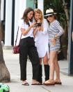 <p>Ana de Armas smiles while showing friends something on her phone on Tuesday in L.A. </p>