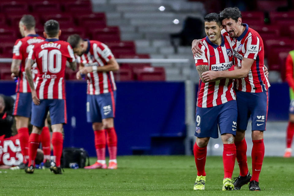 Luis Suárez (segundo a la derecha) celebra con su compañero Stefan Savic tras anotar el gol que le dio al Atlético de Madrid la victoria 1-0 ante Alavés en la Liga española, el domingo 21 de marzo de 2021. (AP Foto/Manu Fernández)