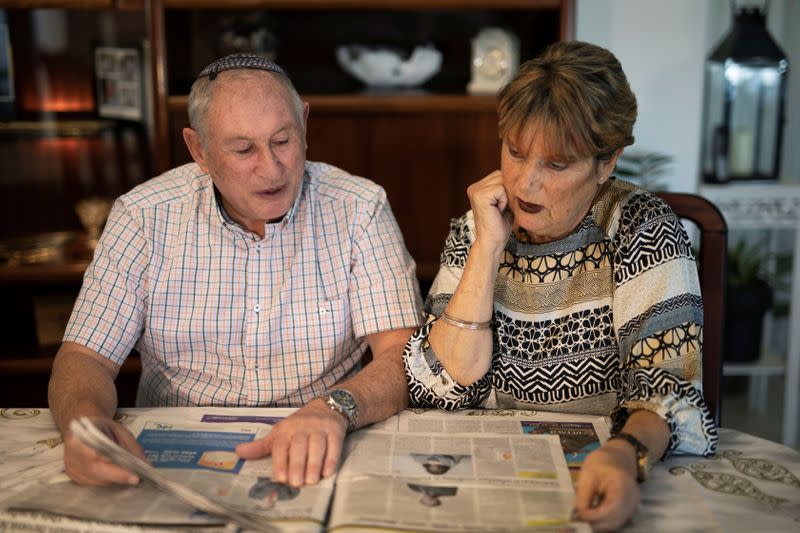 British immigrants to Israel, Harvey Seitz, and his wife Susan, look at Jewish newspapers they received from Britain, during an interview with Reuters in Ashkelon, Israel