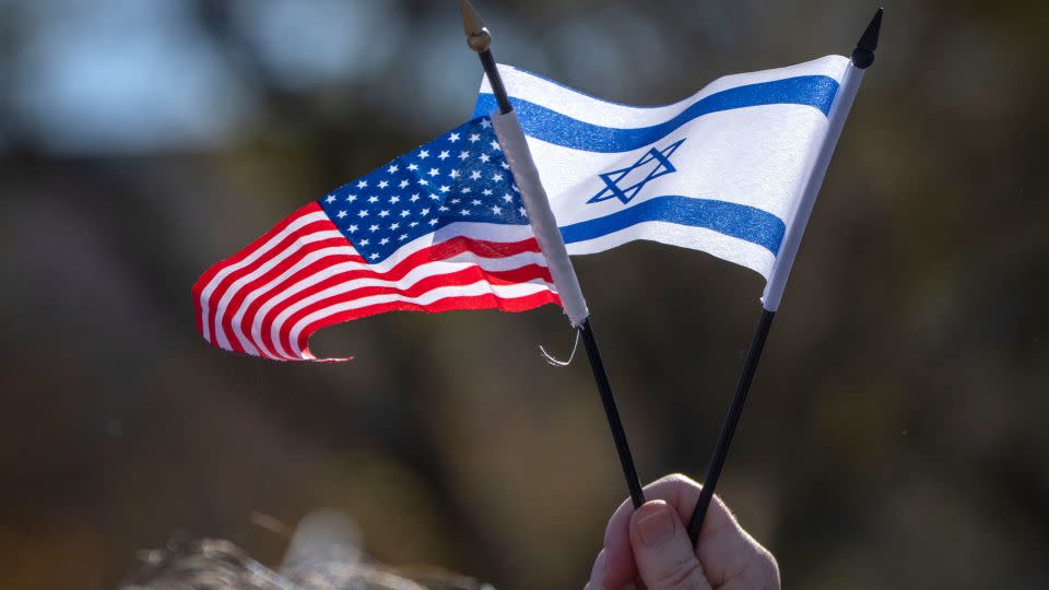A "March for Israel" attendee holds miniature US and Israeli flags at the rally Tuesday in Washington, DC. - Mark Schiefelbein/AP