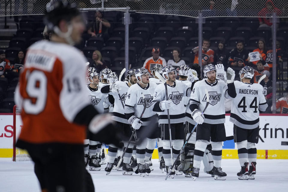 Los Angeles Kings' players celebrate past Philadelphia Flyers' Garnet Hathaway after wining an NHL hockey game, Saturday, Nov. 4, 2023, in Philadelphia. (AP Photo/Matt Slocum)