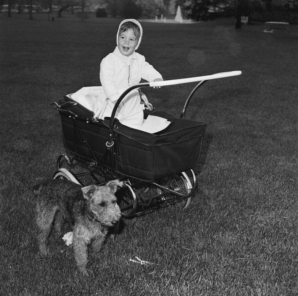 John Kennedy Jr. in a stroller next to the Kennedys’ dog Charlie on the White House grounds in 1962.