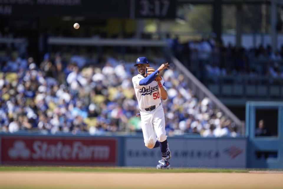 Dodgers shortstop Mookie Betts makes a throw to first during the eighth inning of a game against the Cardinals on Thursday.