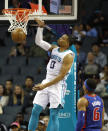 Charlotte Hornets' Miles Bridges (0) slaps down a dunk as Detroit Pistons' Bruce Brown (6) can only watch during the second half of an NBA preseason basketball game in Charlotte, N.C., Wednesday, Oct. 16, 2019. The Pistons won 116-110. (AP Photo/Bob Leverone)