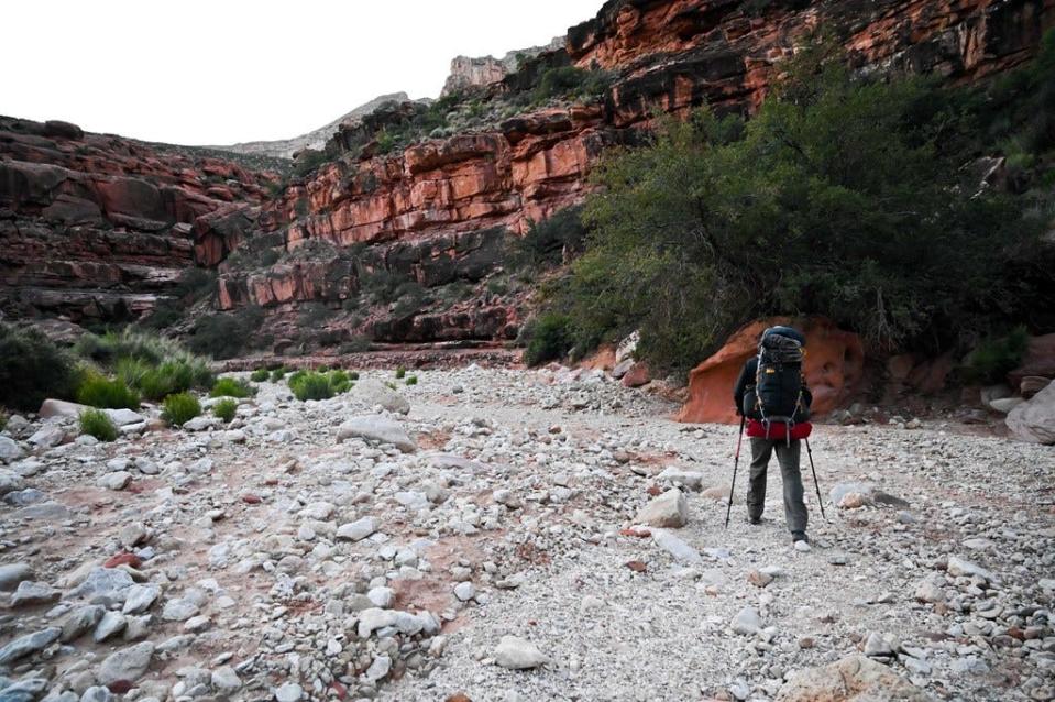 A hiker makes his way through a canyon on the Havasupai Indian Reservation.