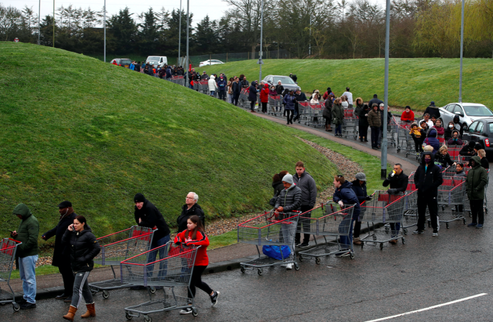 Shoppers queue round the block to get into a Watford branch of Costco. (Reuters)